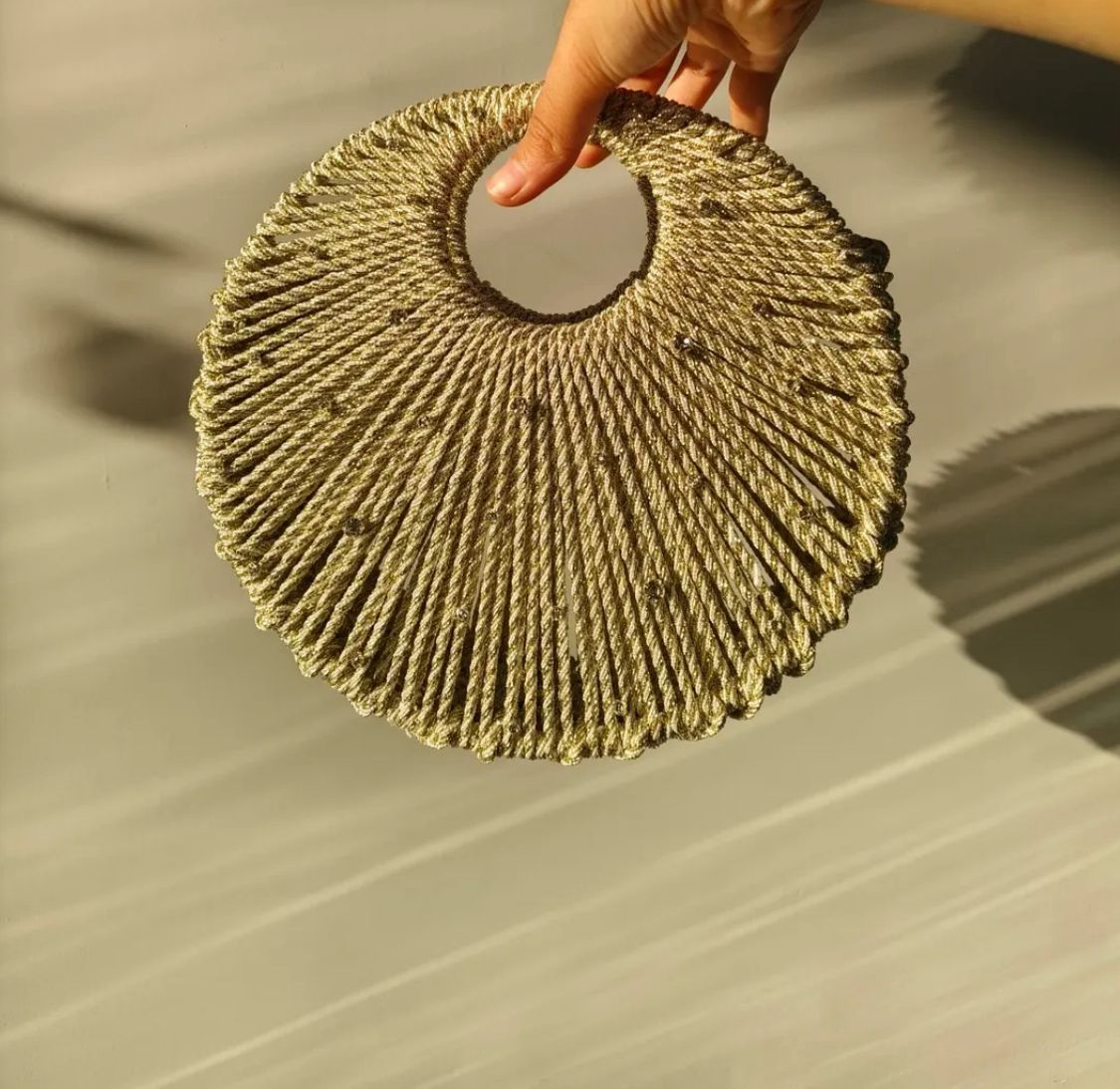 Golden Handwoven Circular Handle Statement Bag