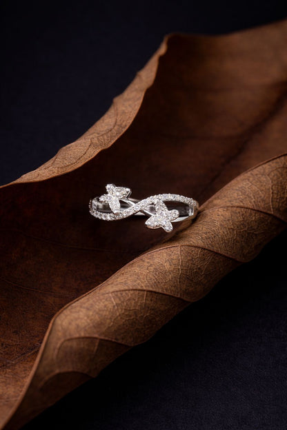 Elegant White Gold Diamond Infinity Ring with Dual Floral Motifs
